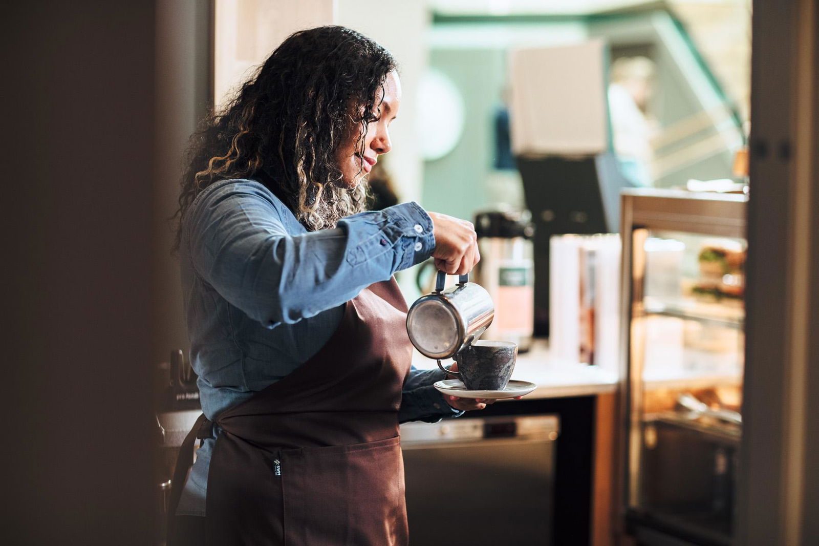 Barista prepares coffee for espresso machine