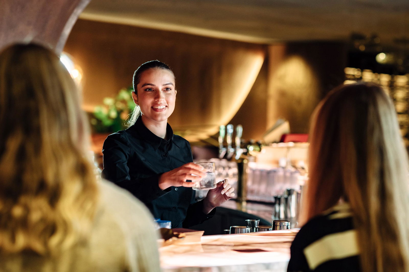 Bartender serving customers at the bar