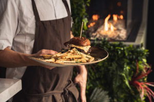 Servitør med hamburger fra Sofienlund Spiseri